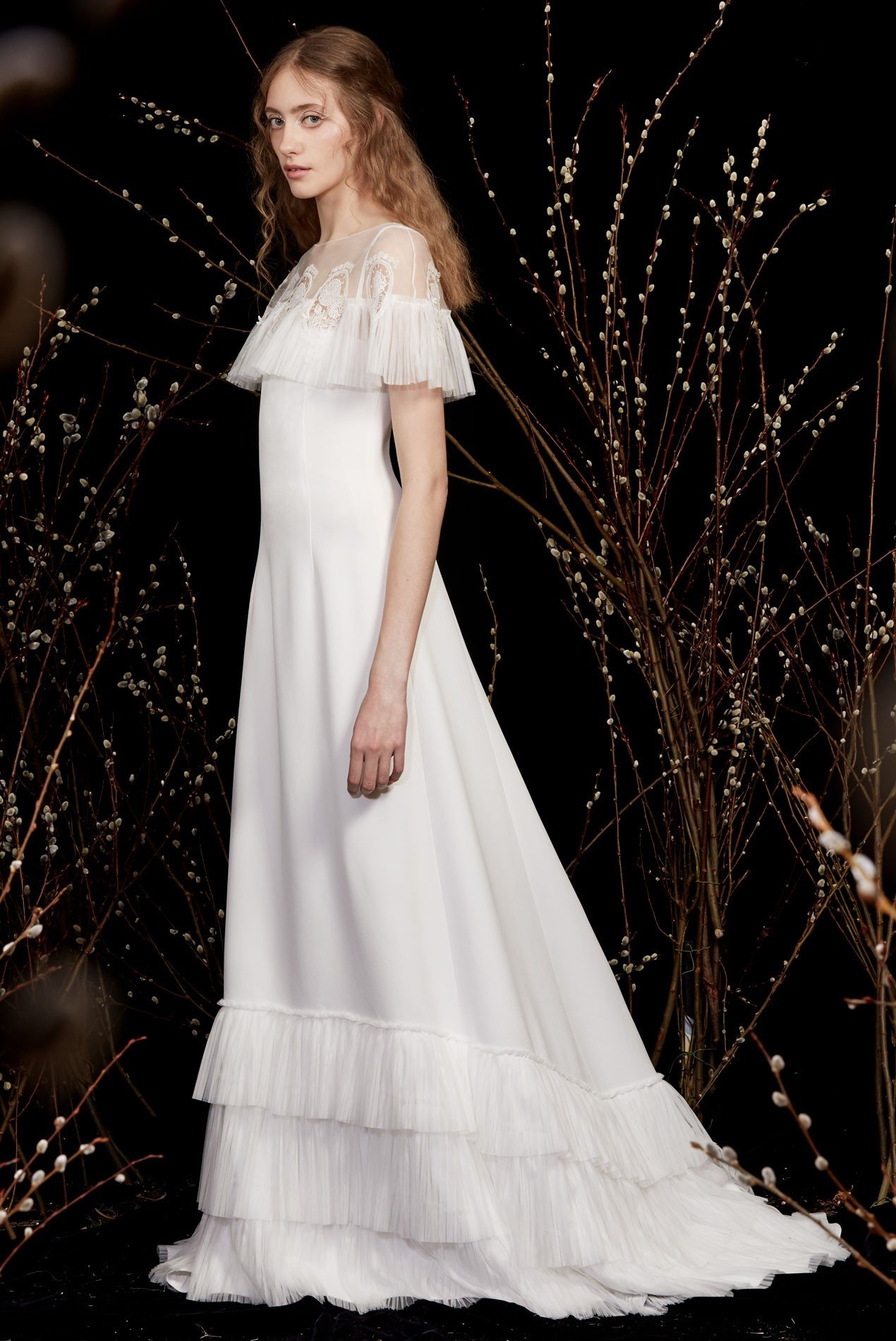 crepe gown with pleated tulle ruffle hem and pleated tulle capelet with medallion embroidery
