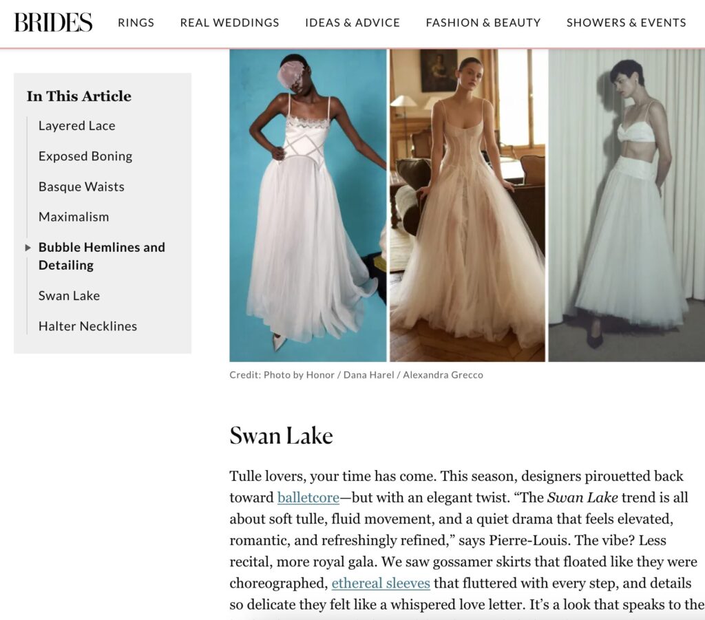 Three models in flowing white wedding dresses, each with unique silhouettes and tulle details, stand posing elegantly.