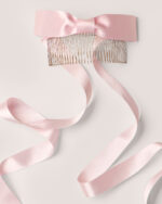 Satin Bow Hair Comb featuring a pink design with a satin bow and long ribbons, displayed on a light background.