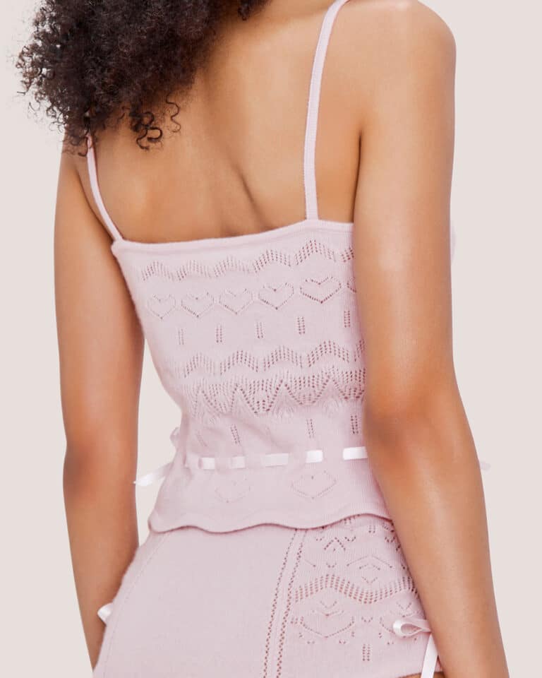 Woman, shown from the back, wearing the Cashmere Heart Knit Camisole in Pink along with the matching shorts.