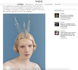 Woman with short blonde hair wears a sheer dress and a swan headpiece against a soft blue background, as shown in Vogue's "Best of Weddings."