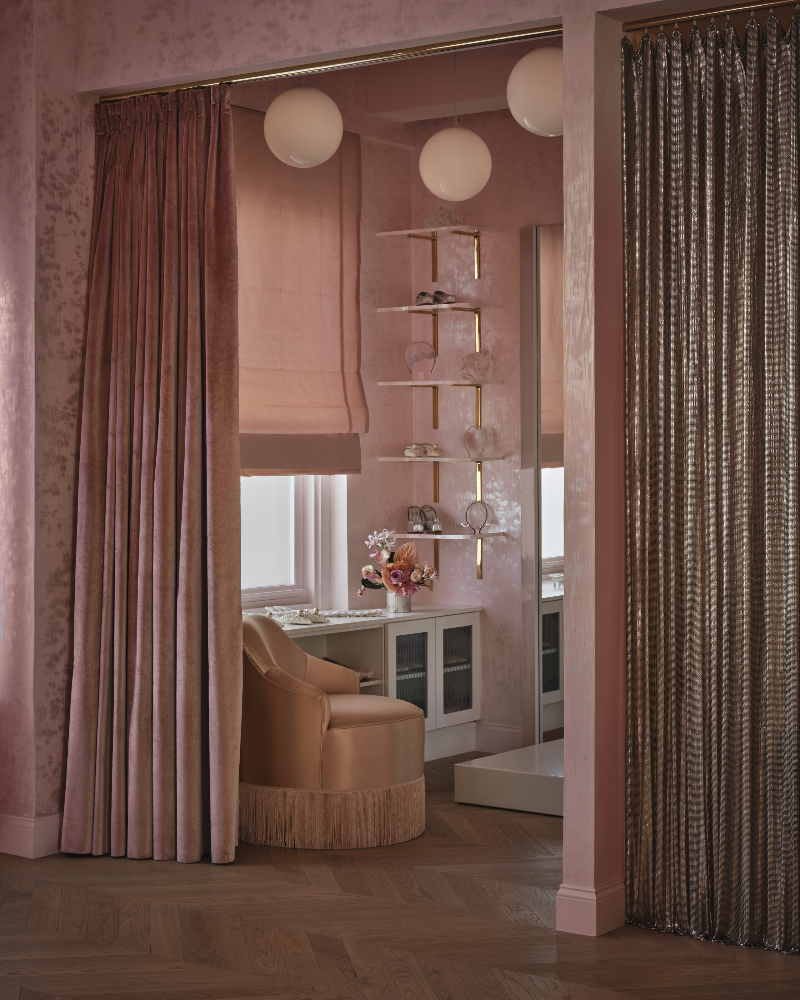 Pink curtains and mirrored accessories display in the HONOR showroom.